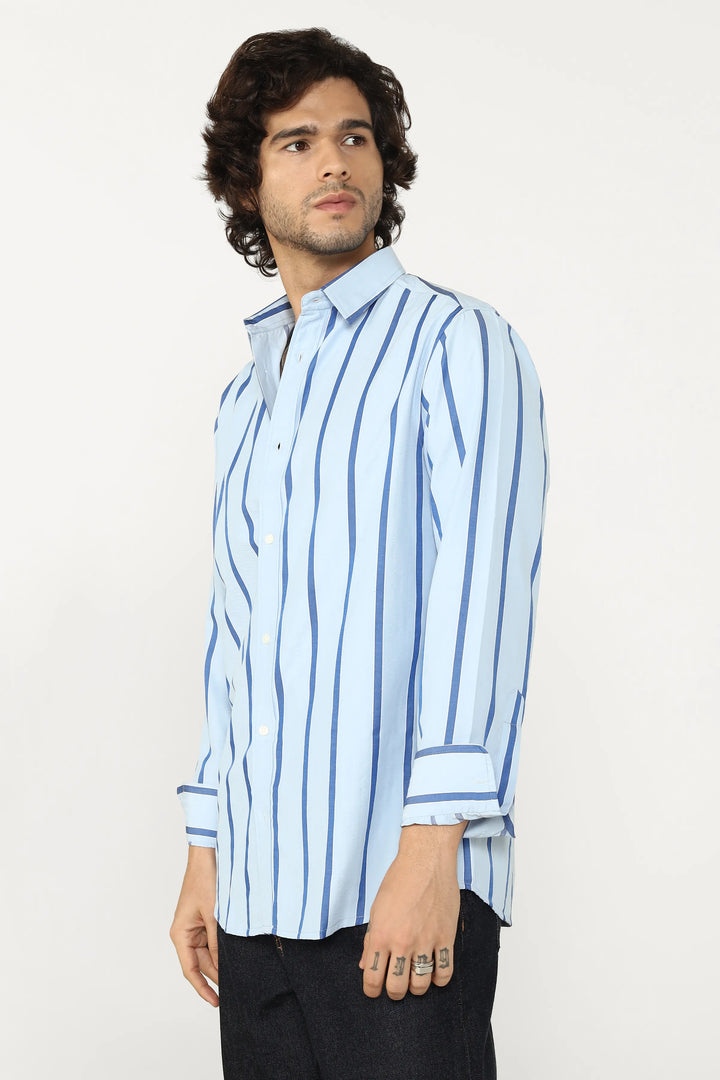 Man wearing a light blue striped shirt on a white background