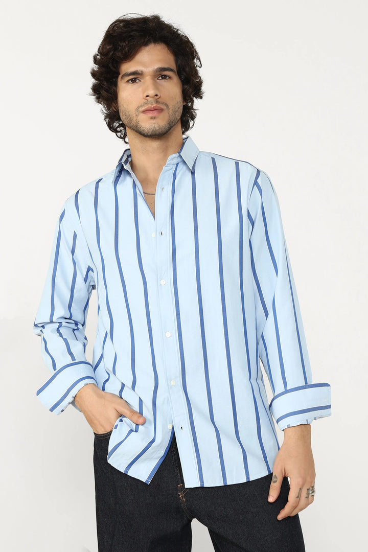 Man wearing a light blue striped shirt against a white background