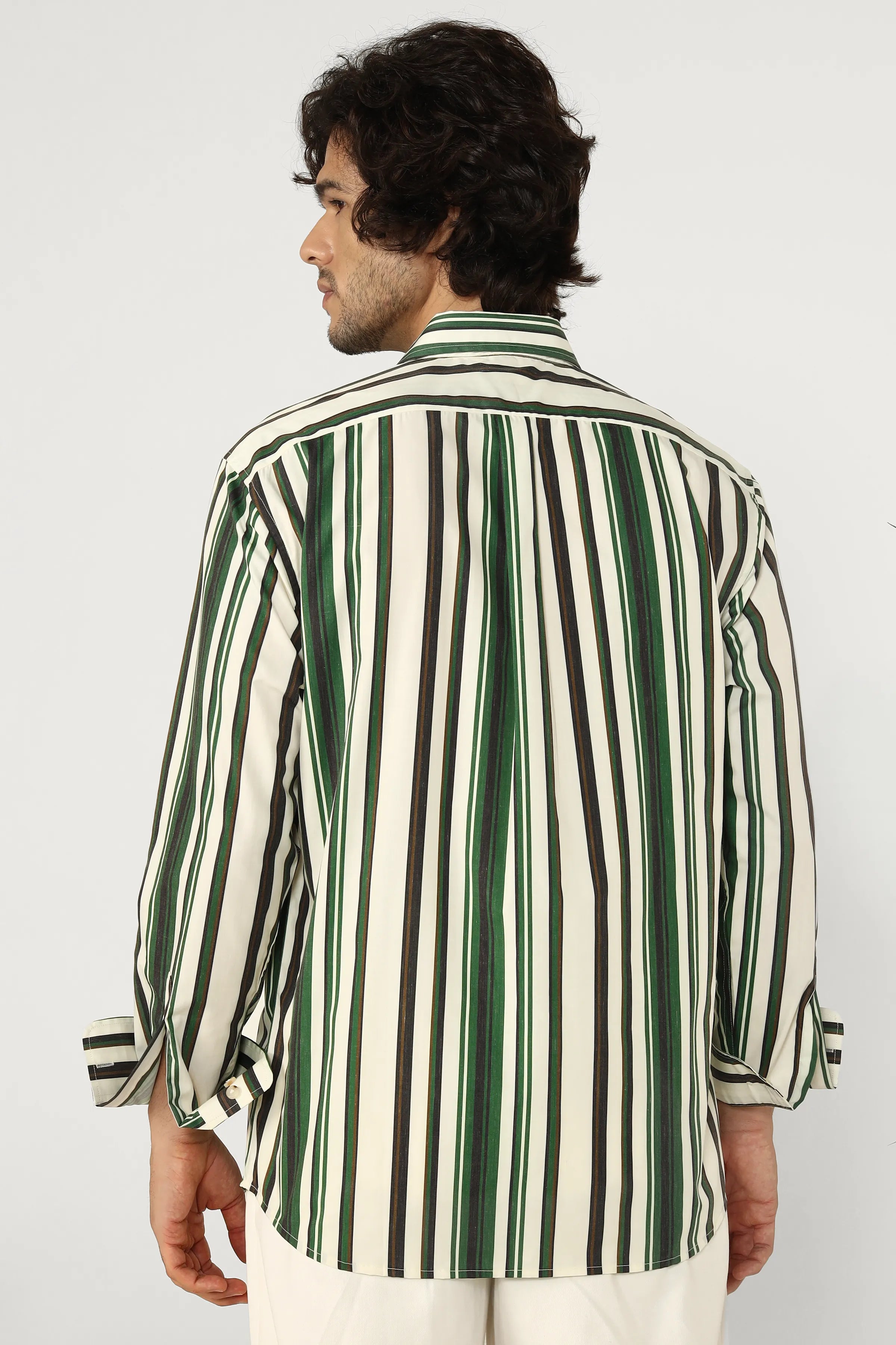Man wearing a green and white striped shirt against a plain background