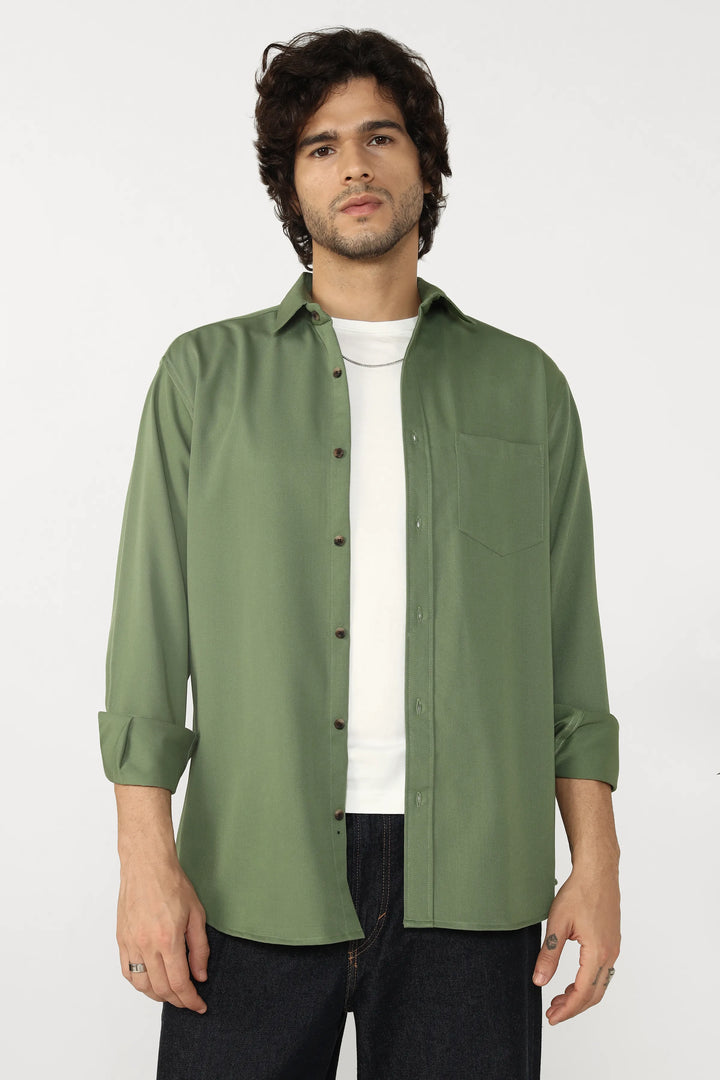 Man wearing a jade cotton twill shirt over a white t-shirt on a white background