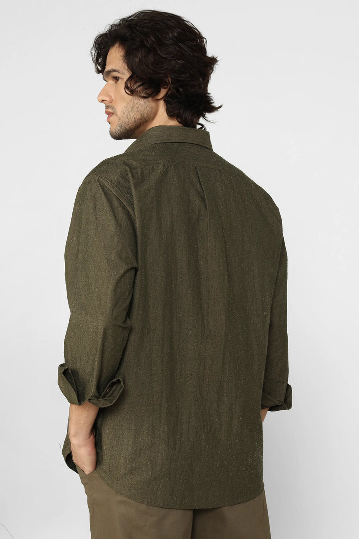 Man wearing a green shirt against a white background