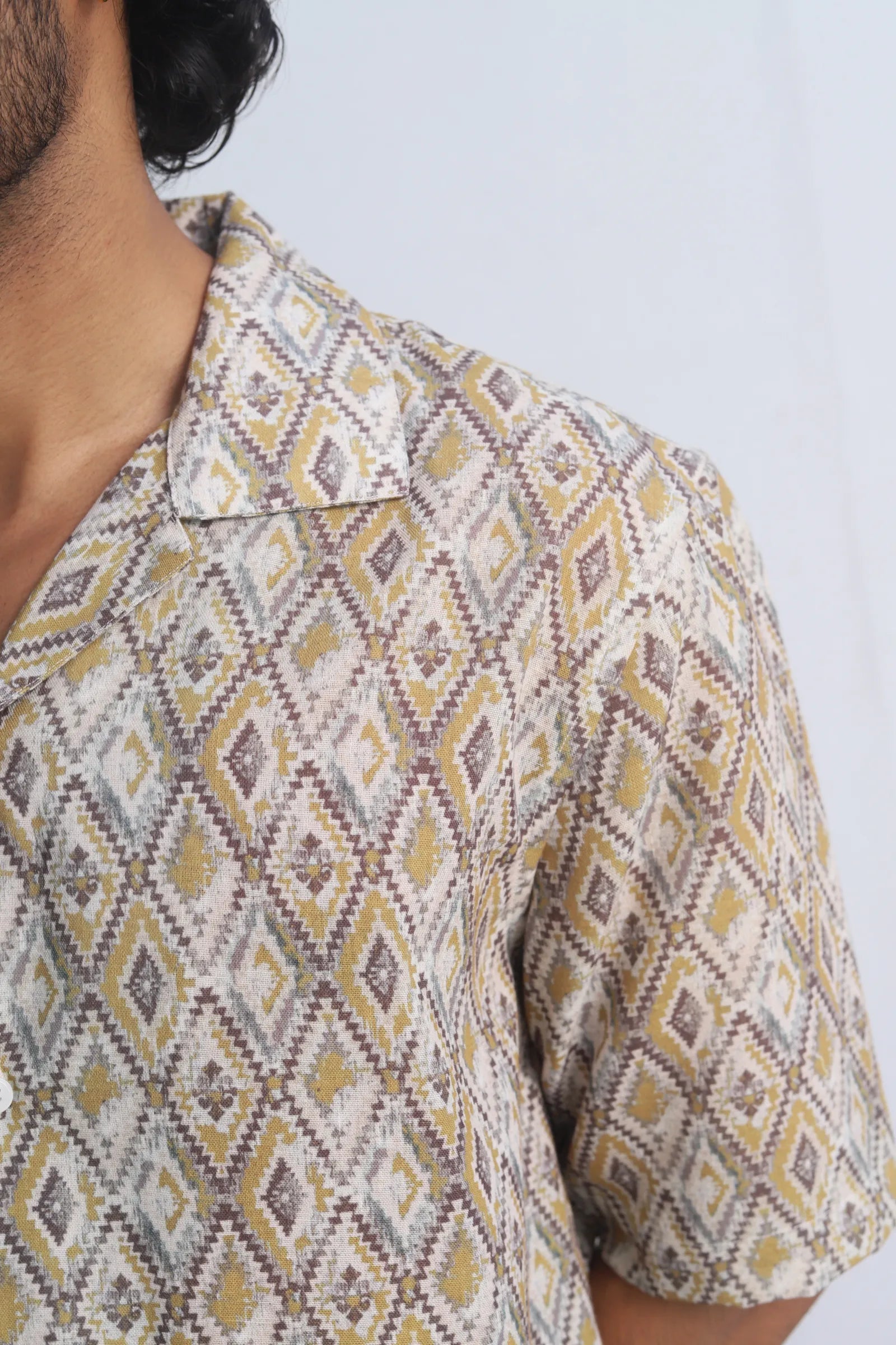 Person wearing a Yellow Harlequin Printed Shirt with a white background