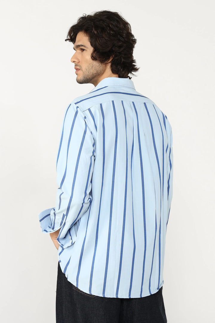 Man wearing a light blue striped shirt on a white background