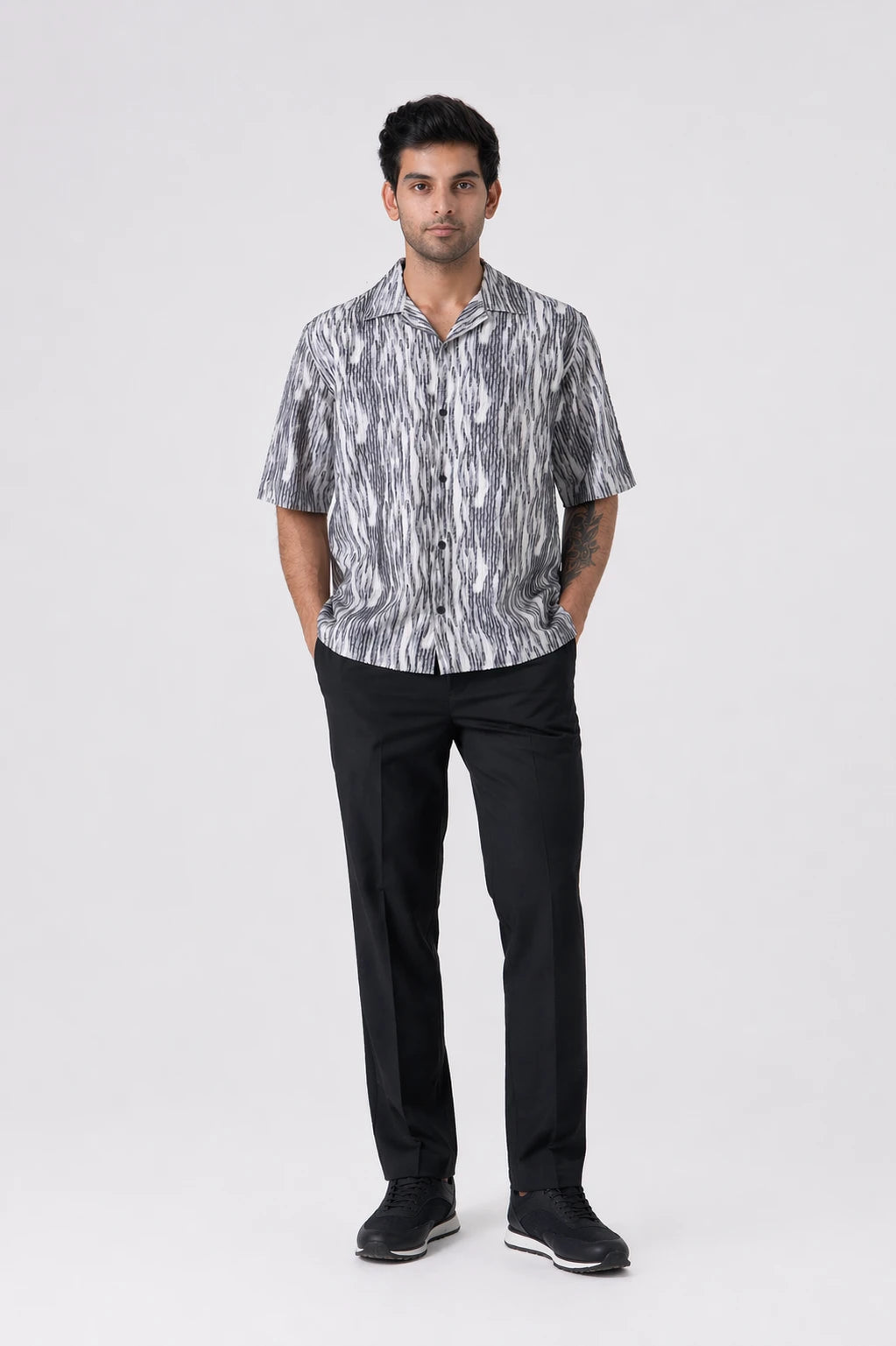 Man wearing a FLOWING ABSTRACT SHIRT - CRAIG and black pants on a white background