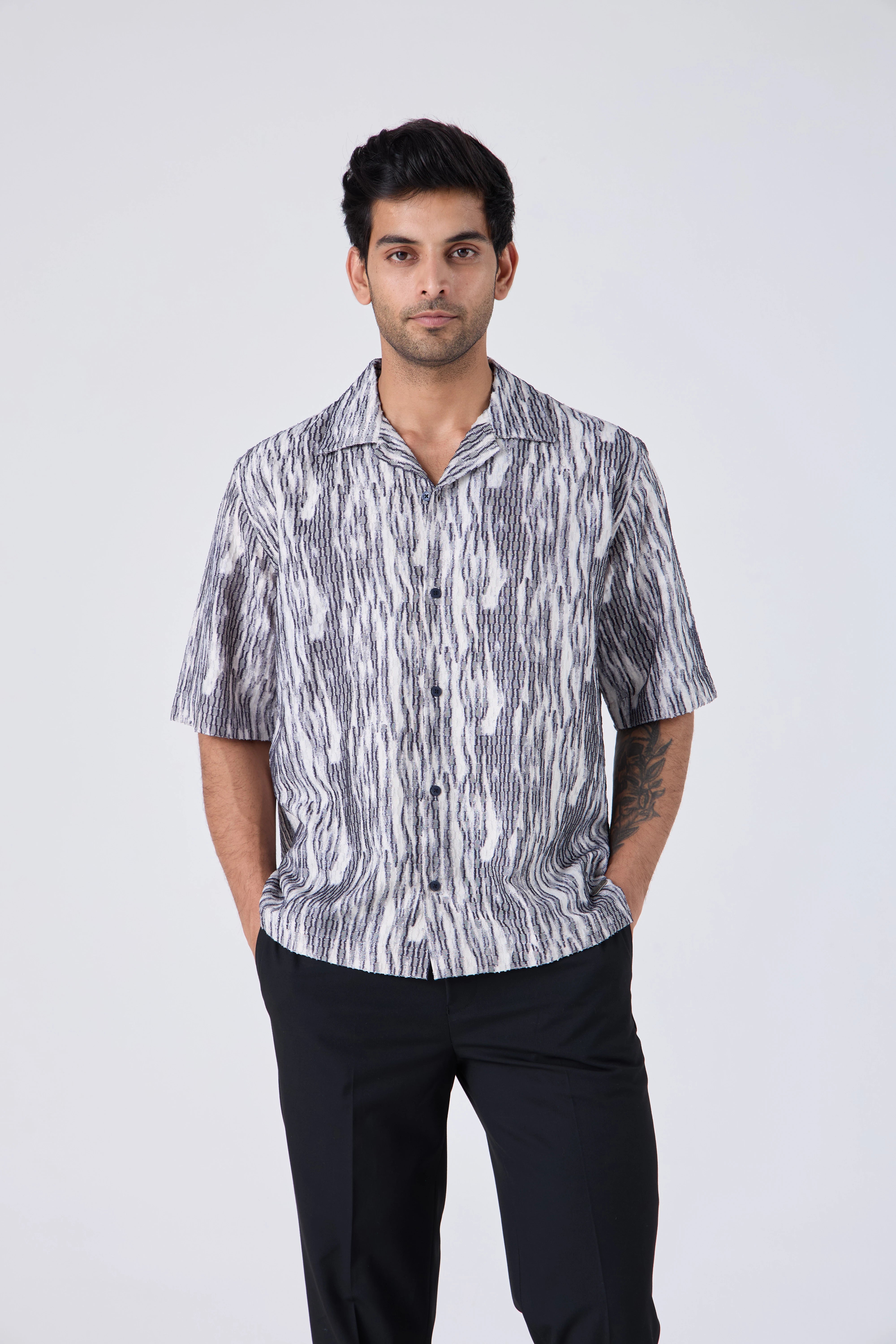 Man wearing a FLOWING ABSTRACT SHIRT - CRAIG and black pants on a white background