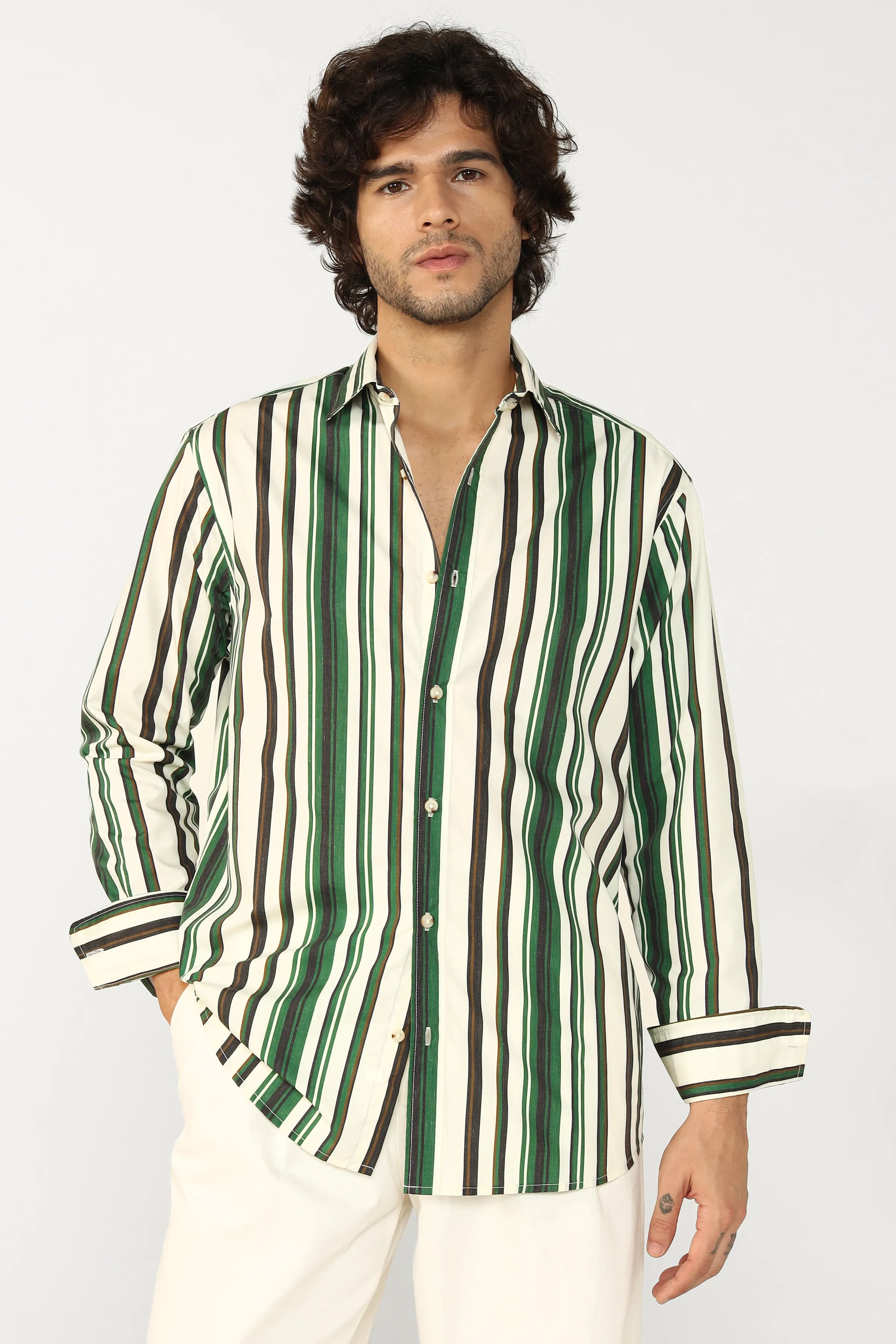 Man wearing a green and white striped shirt against a plain background