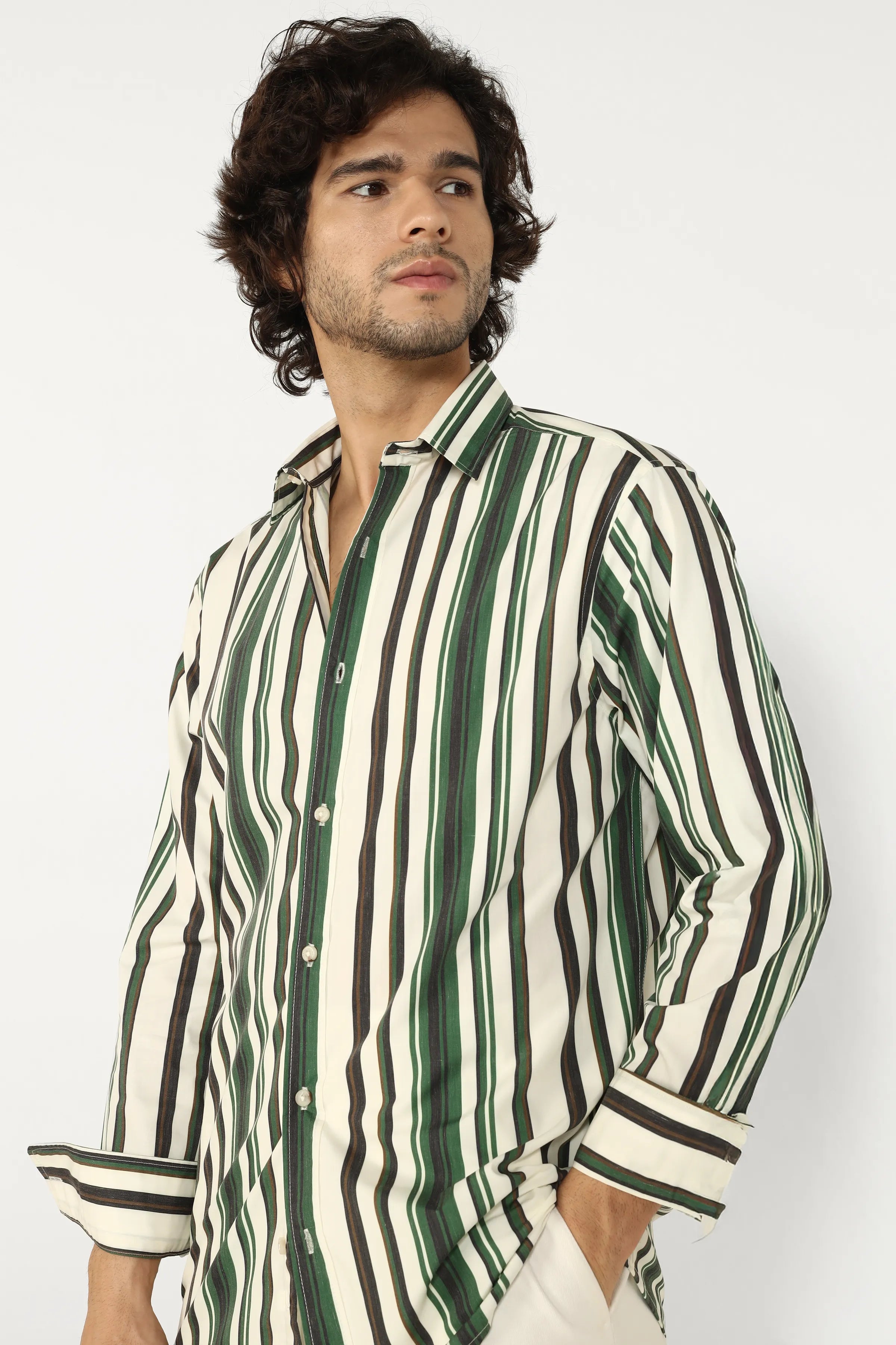Man wearing a green and white striped shirt against a plain background