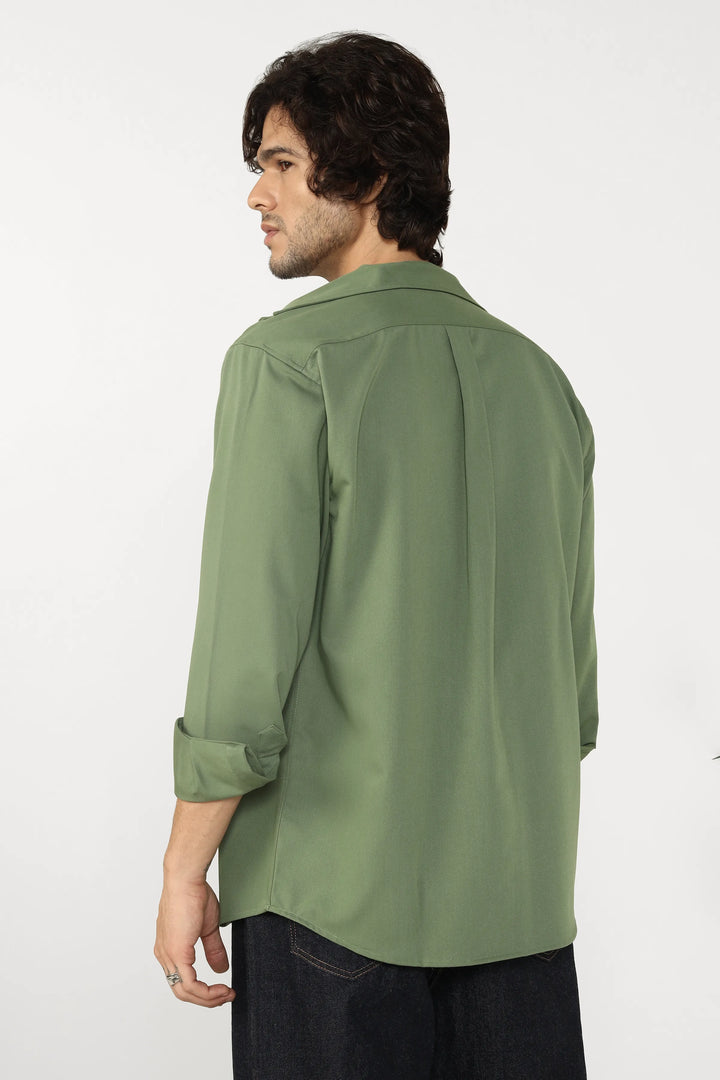 Man wearing a jade cotton twill shirt on a white background