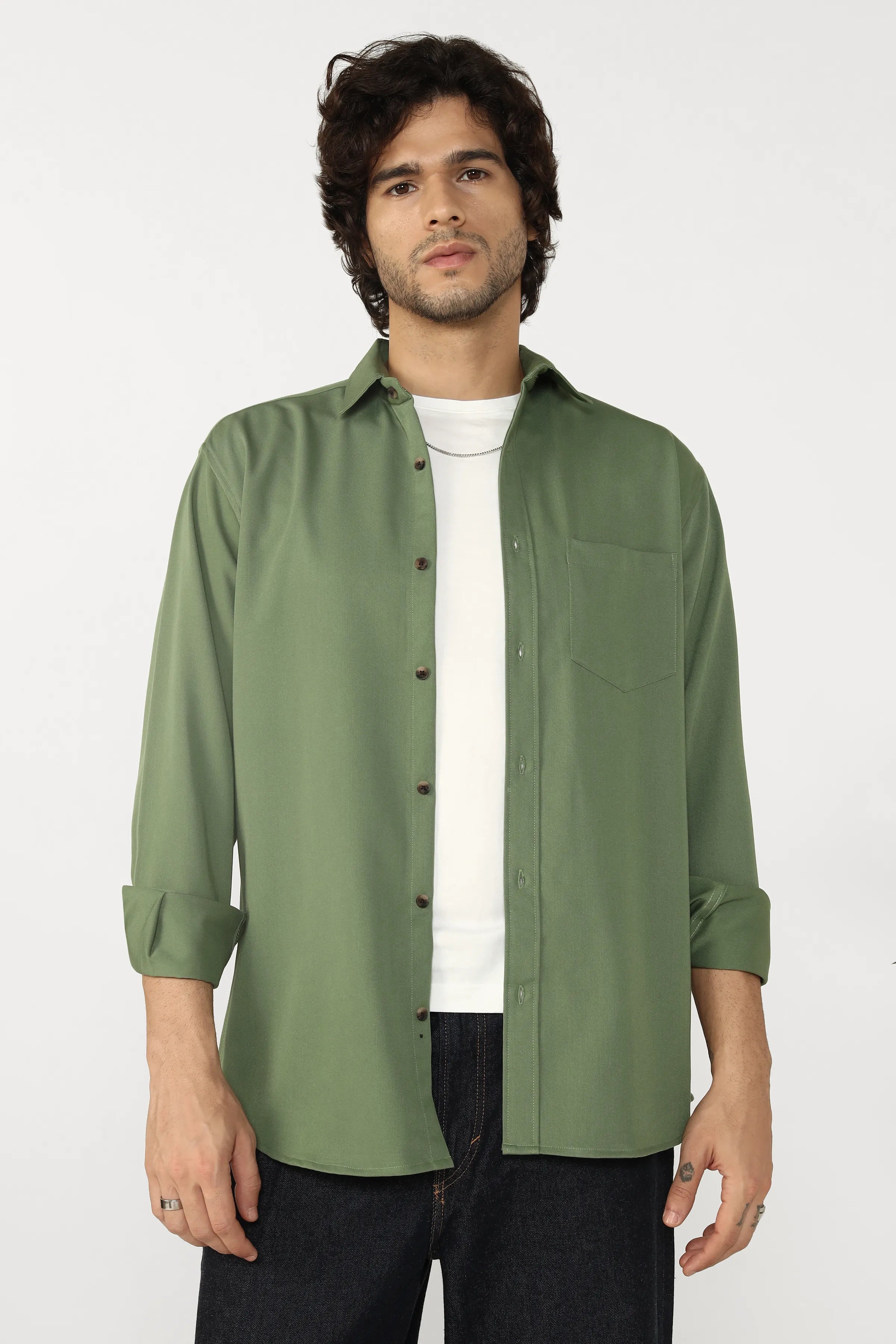 Man wearing a jade cotton twill shirt over a white t-shirt on a white background