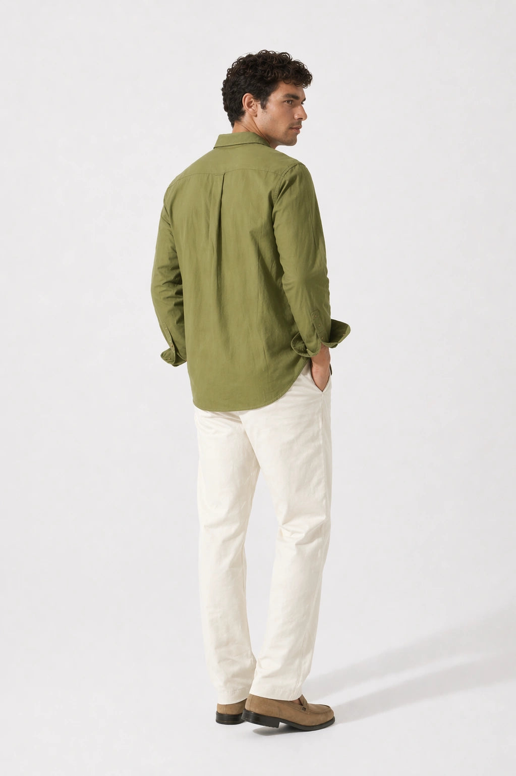 Man wearing a olive cotton shirt and white pants on a white background