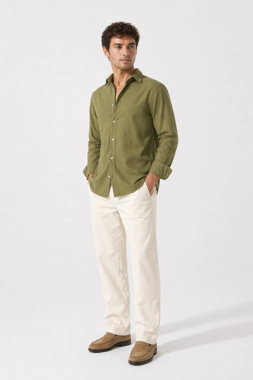 Man wearing a olive shirt and white pants on a white background