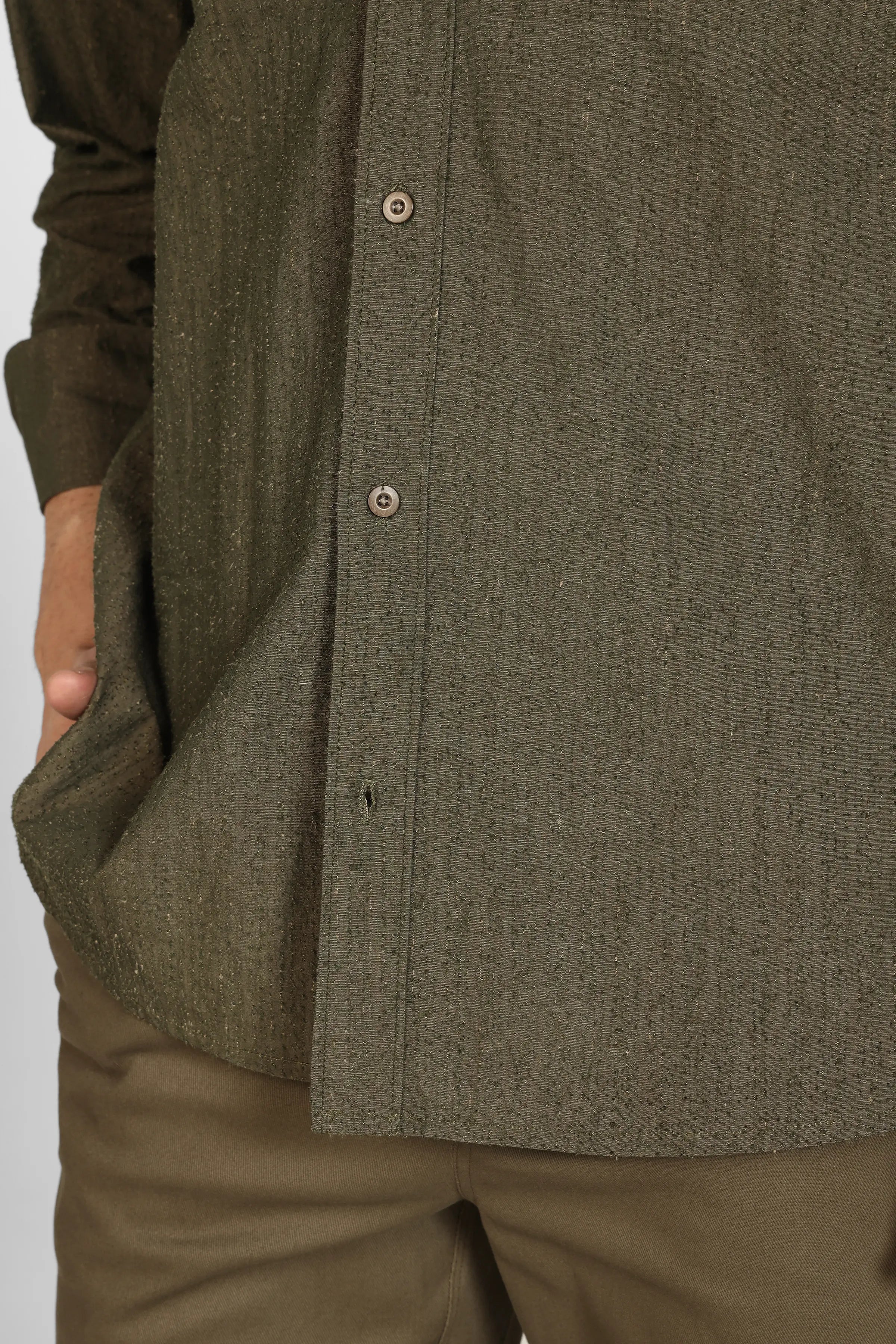 Close-up of a person wearing a Olive Grain Cotton Shirt and pants on a white background