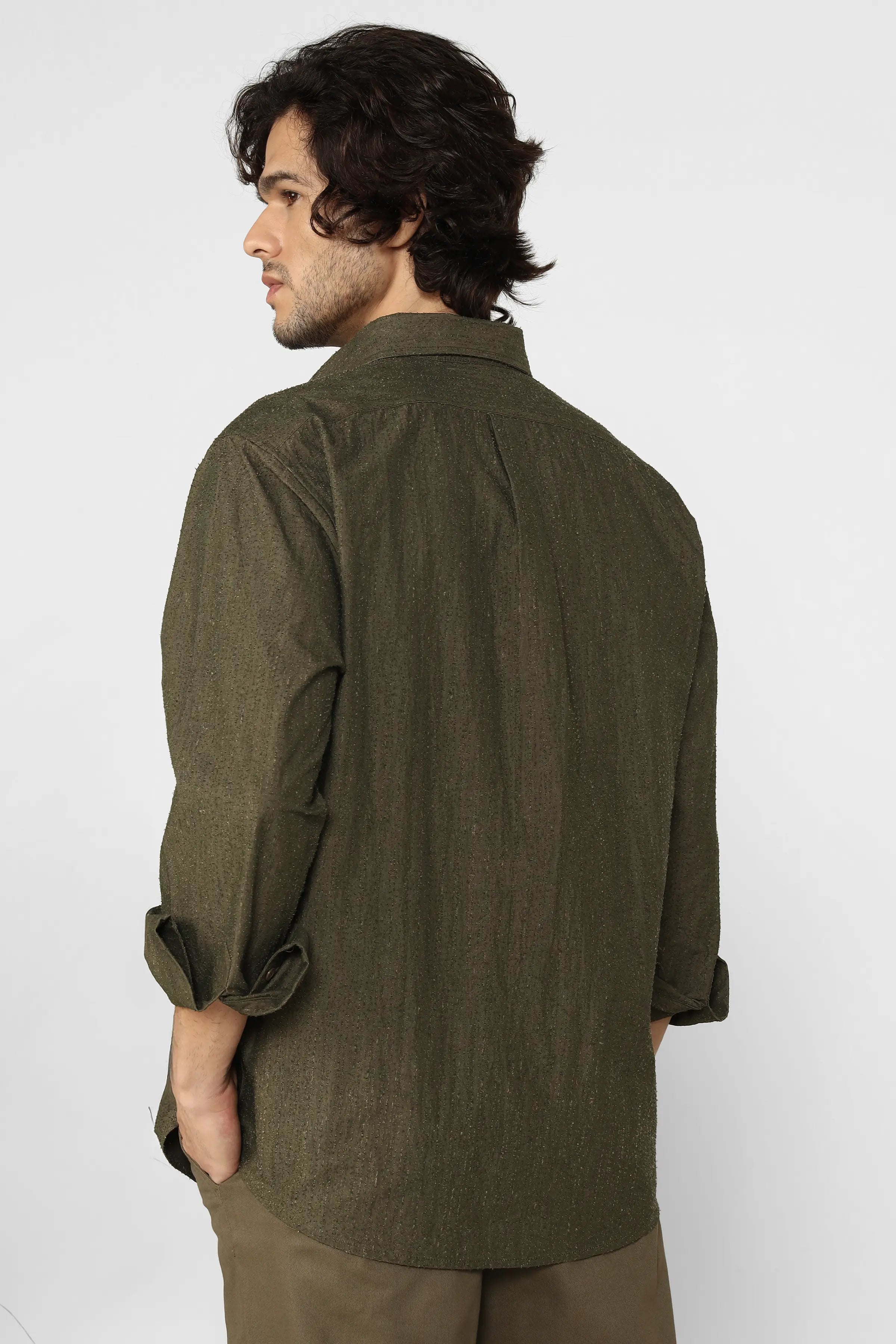 Man wearing a green shirt against a white background