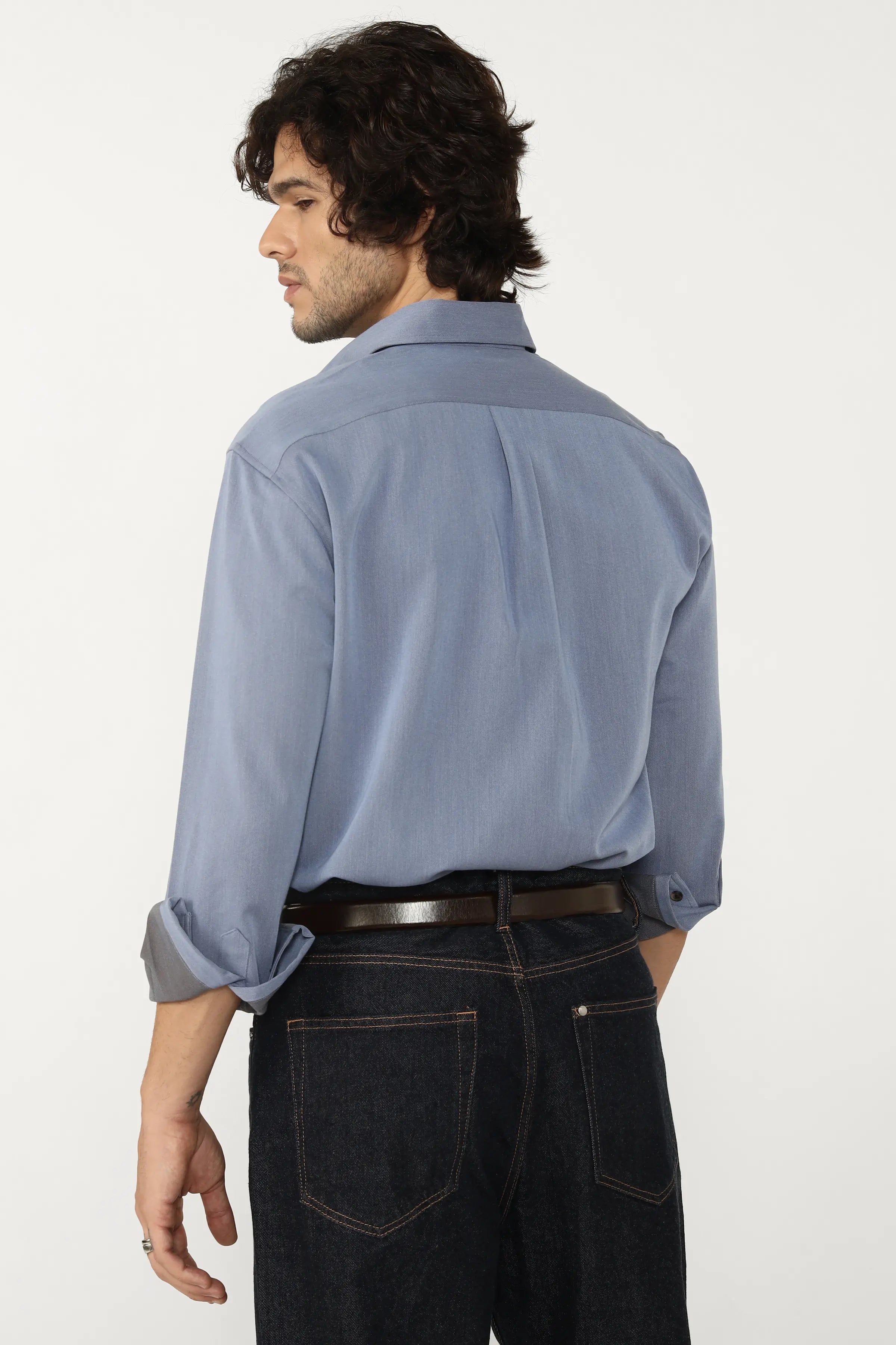 Man wearing a Oxford Cotton Twill Shirt and dark jeans on a white background