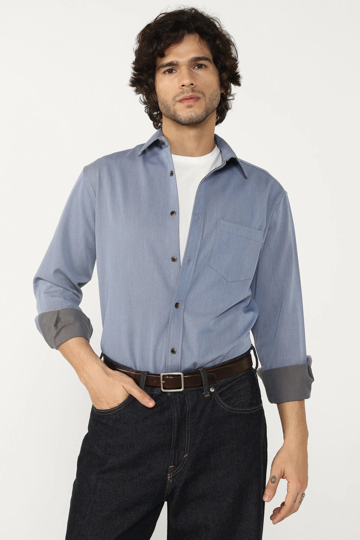 Man wearing a Oxford Cotton Twill Shirt and dark jeans on a white background
