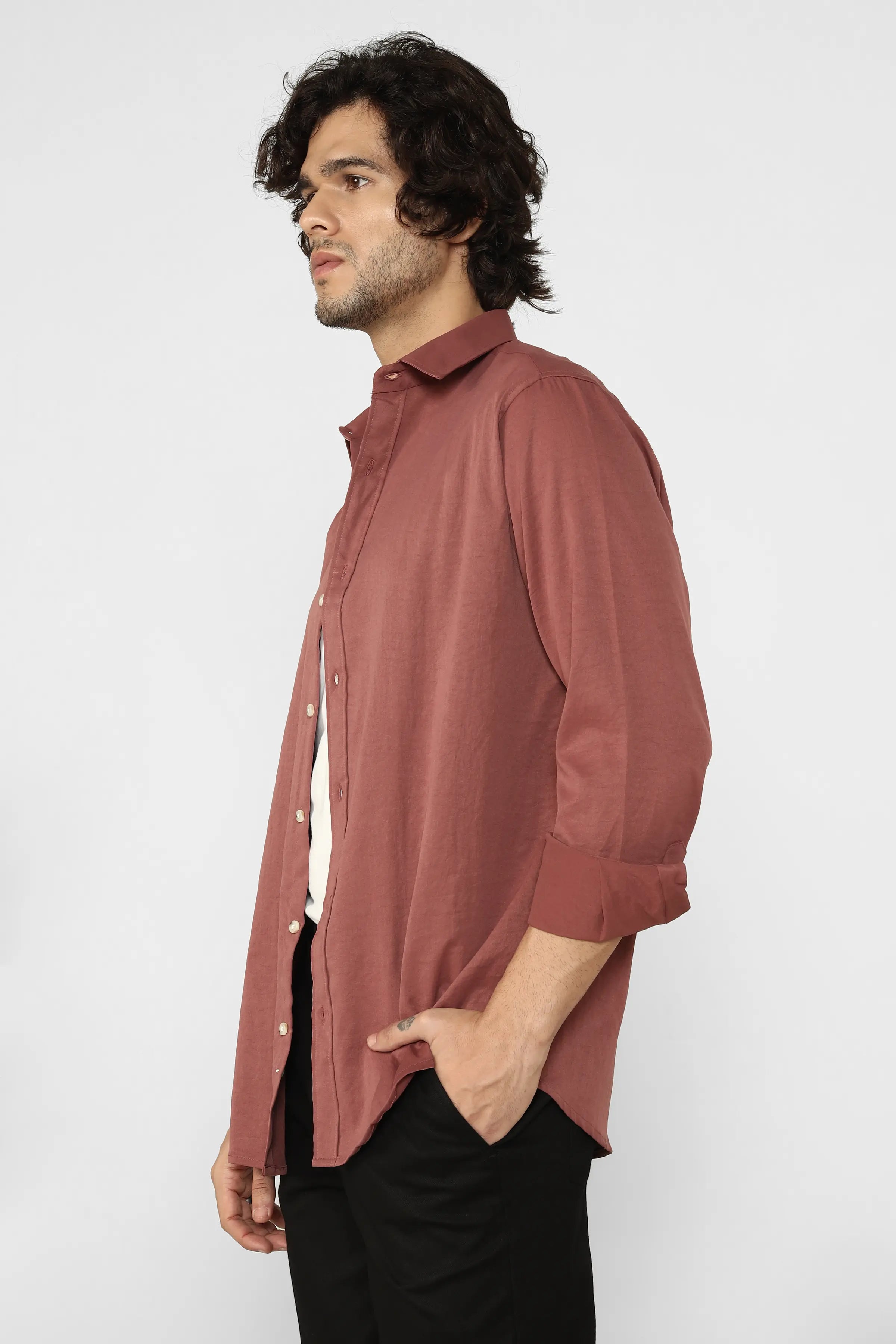 Man wearing a long Rust Creased Cotton Shirt against a white background