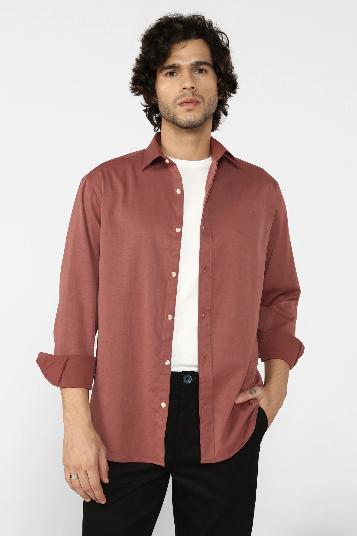 Man wearing a Rust Creased Cotton Shirt over a white t-shirt on a white background